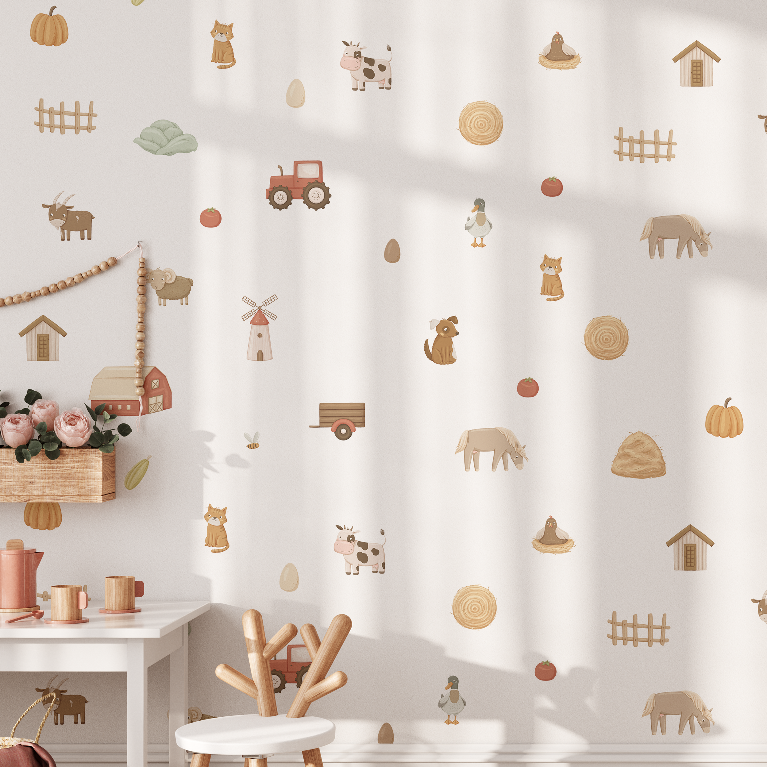 Children’s playroom with a white table and chairs, toy tea set, and My Store On The Farm Wall Decals featuring animals, tractors, and barns. Sunlight highlights these soft, neutral farm-themed illustrations.