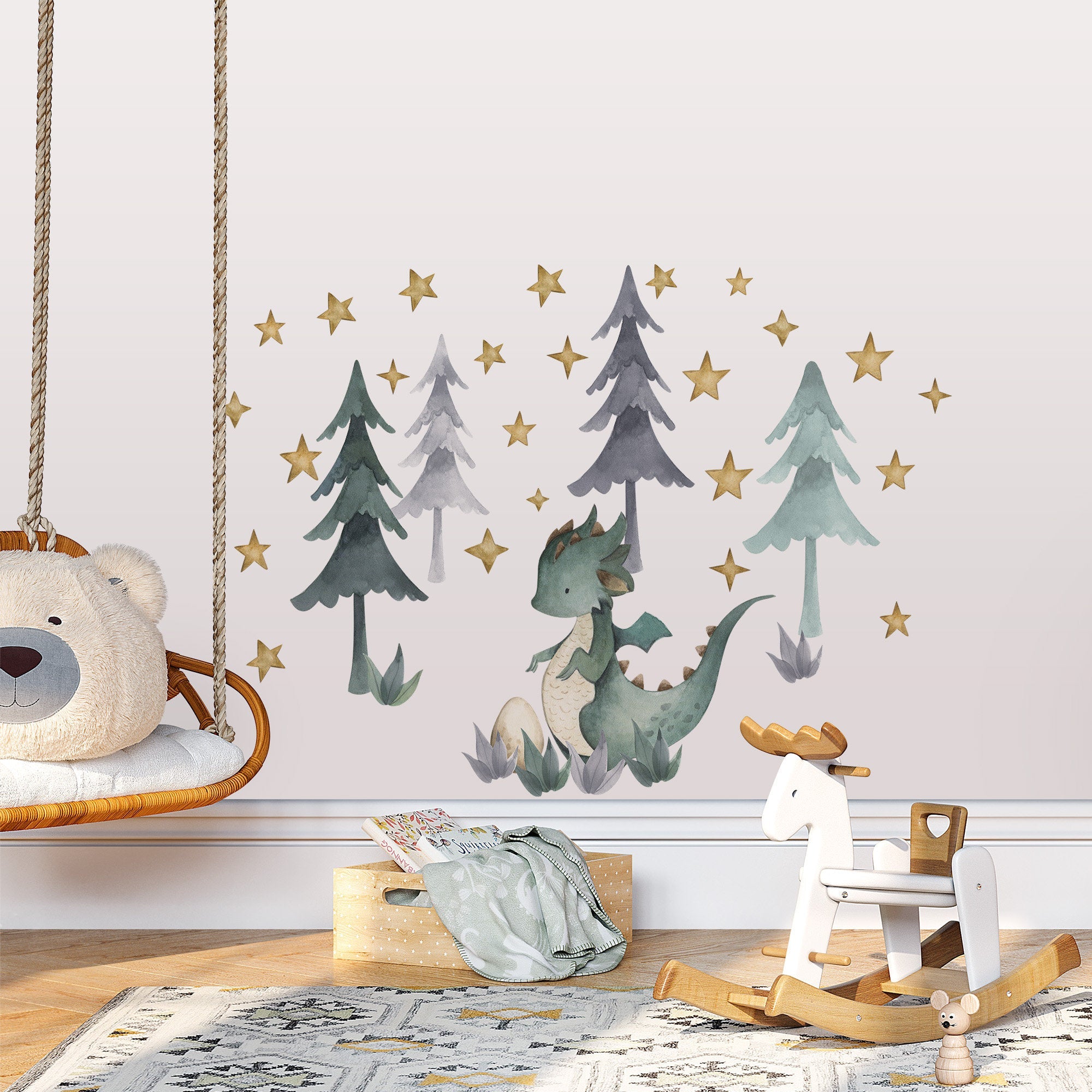 A childrens room includes My Stores Green Dragon Stickers with trees and stars for easy use. A wooden rocking horse and a swing seat with a bear cushion enhance the playful theme, while a patterned rug completes the decor.