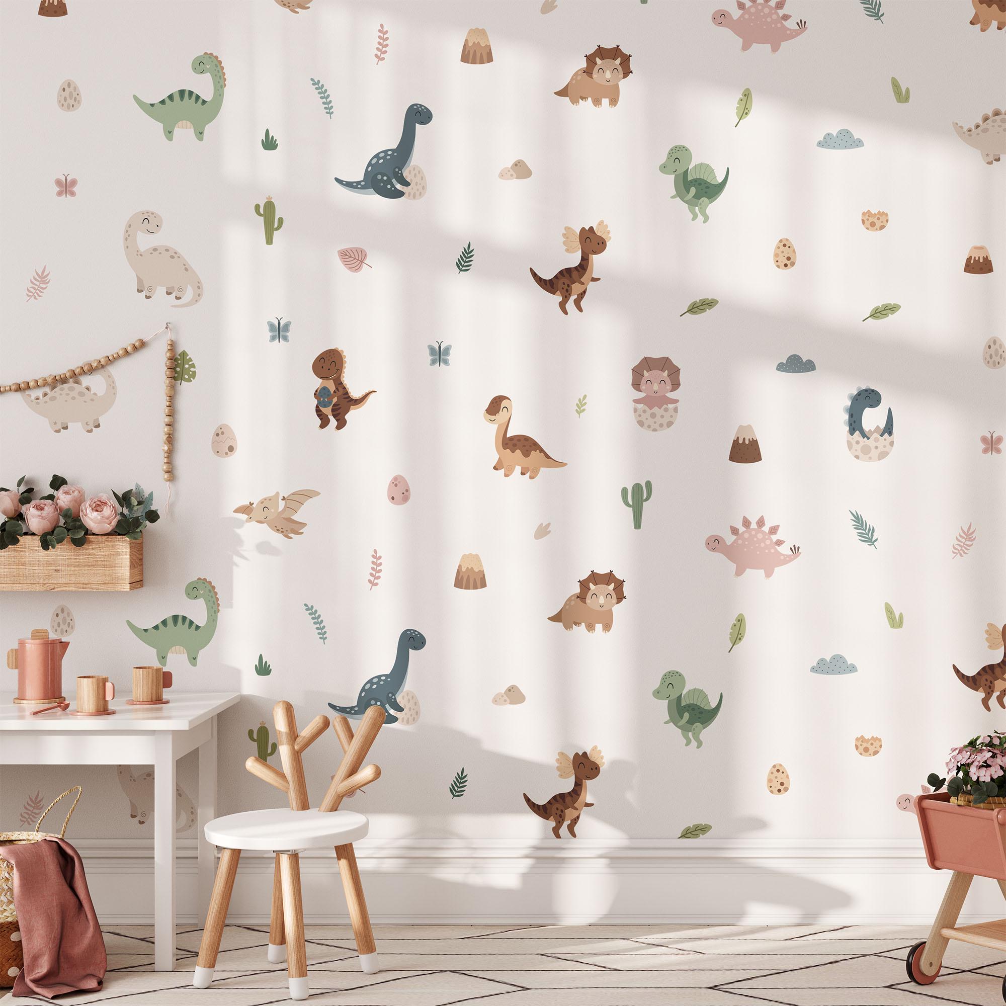 A childrens playroom showcases a white wall with My Stores Fun Dinosaurs Stickers. It has a small white table, a chair, and a bench adorned with plush toys. Sunlight pours in, casting gentle shadows on the floor.