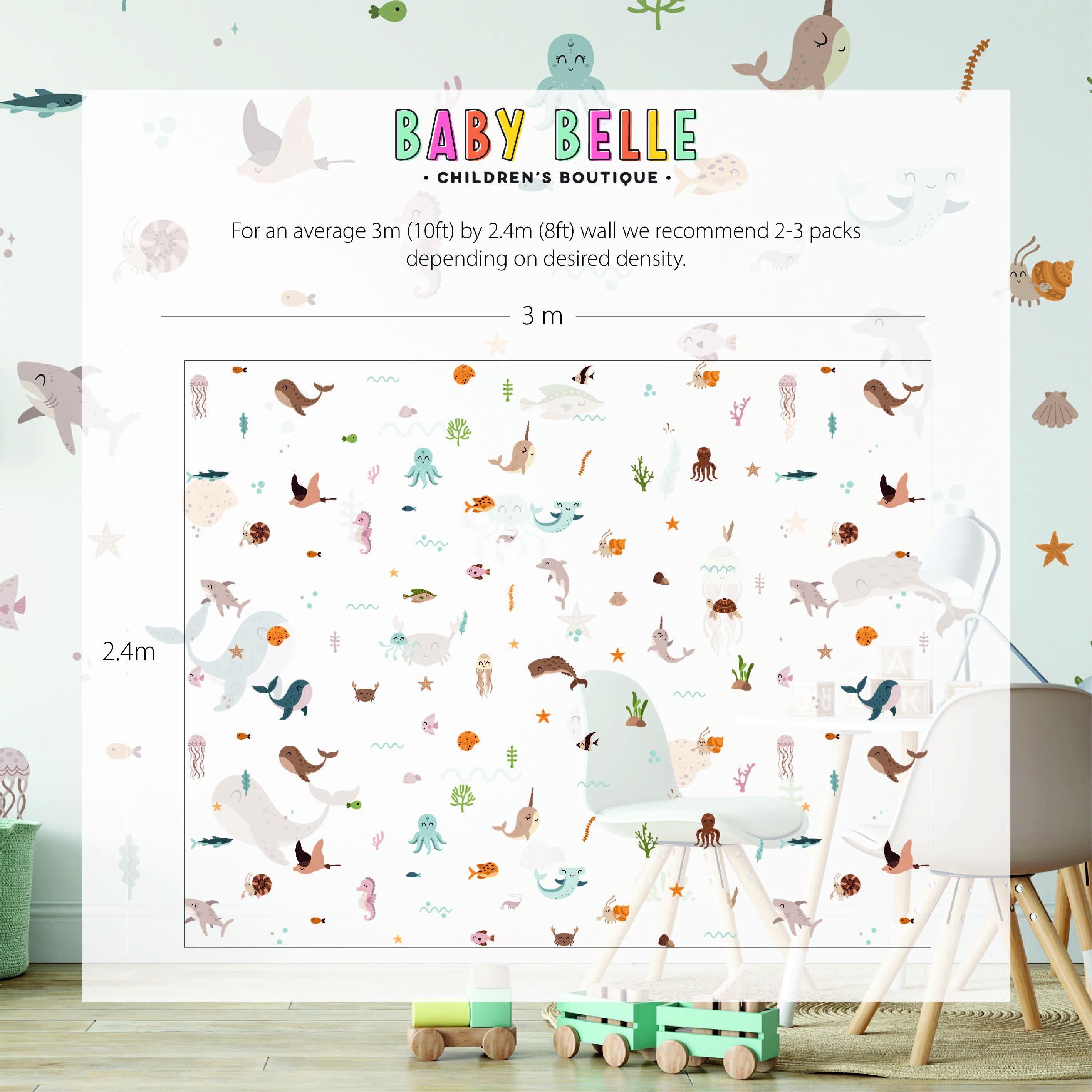 The childrens room features a 3m x 2.4m wall adorned with My Stores Ocean Animals Stickers, depicting whales, dolphins, turtles, and sea plants. A white chair sits amid colorful toys, creating an enchanting underwater world.
