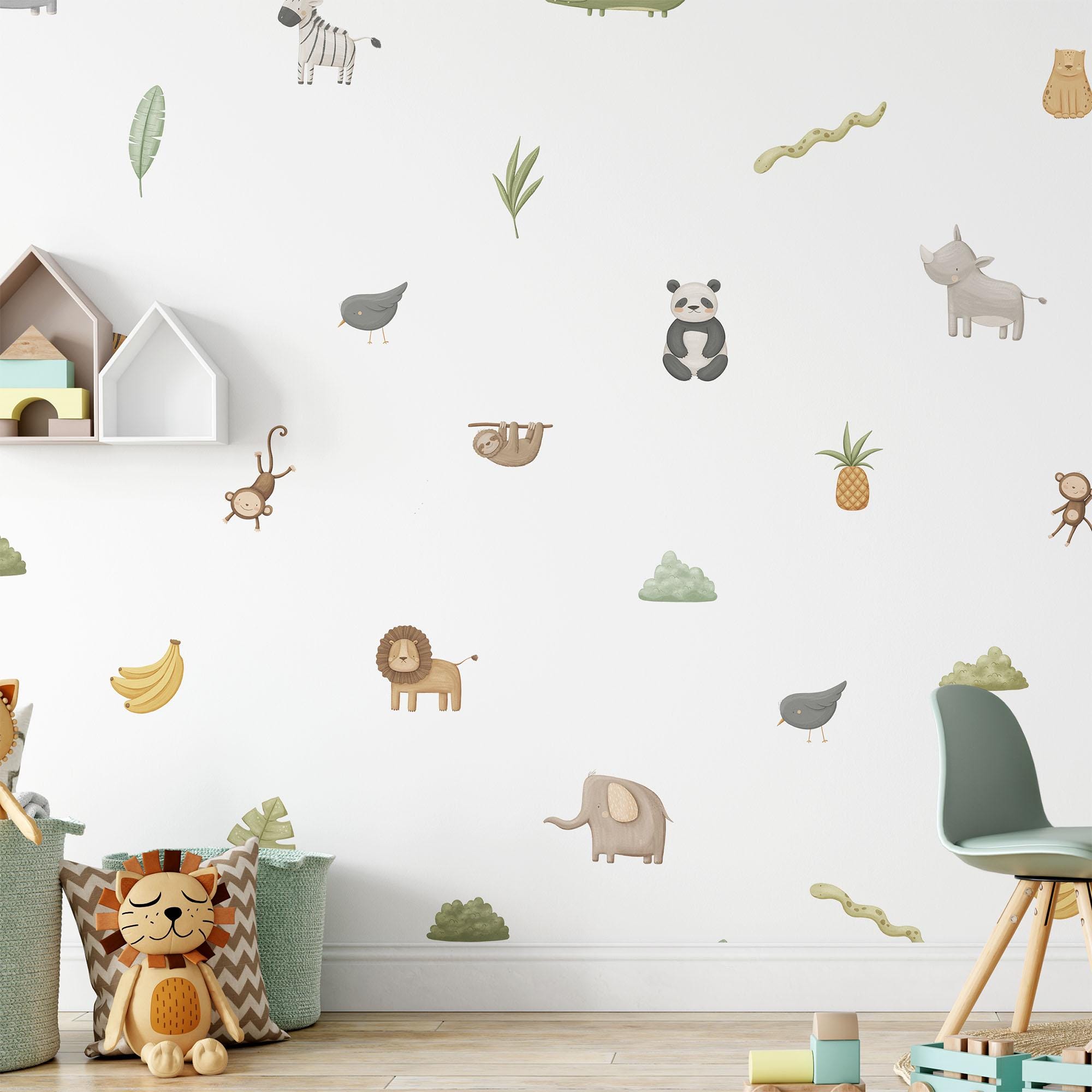 A charming childrens room adorned with My Stores Safari & Jungle Animal Stickers, featuring zebras, pandas, lions, and elephants. The nursery decor includes a house-shaped shelf, a green chair, and plush toys scattered on the floor.